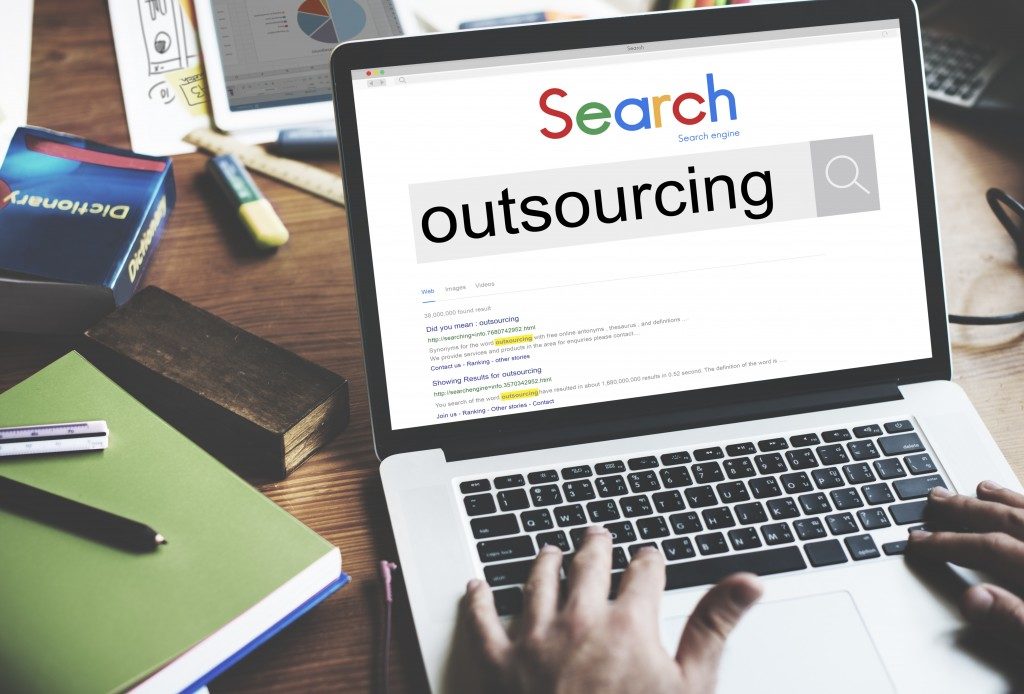 person researching the word outsourcing