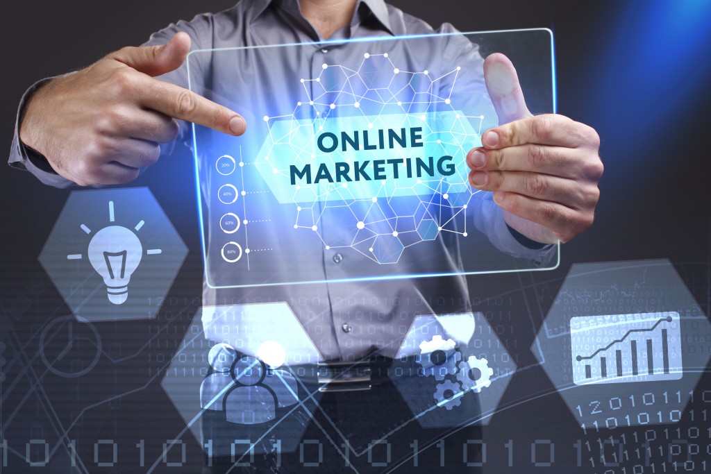 man holding a tablet with online marketing