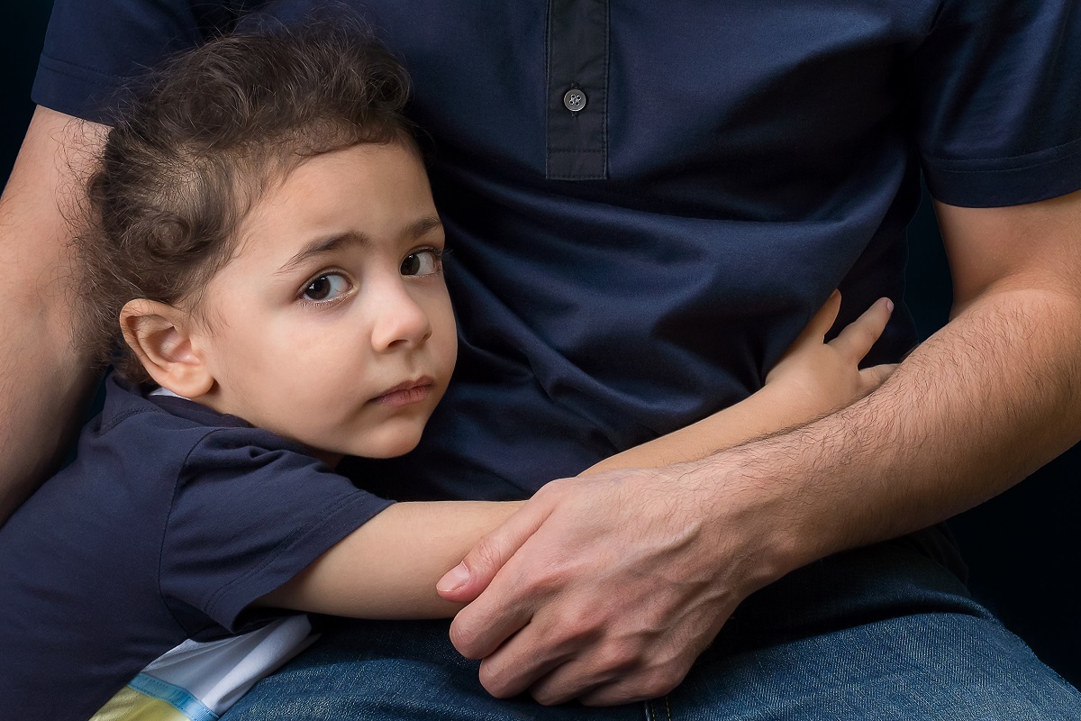 Child hugging her father