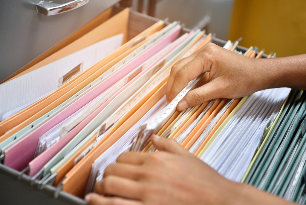 a person scanning a file cabinet