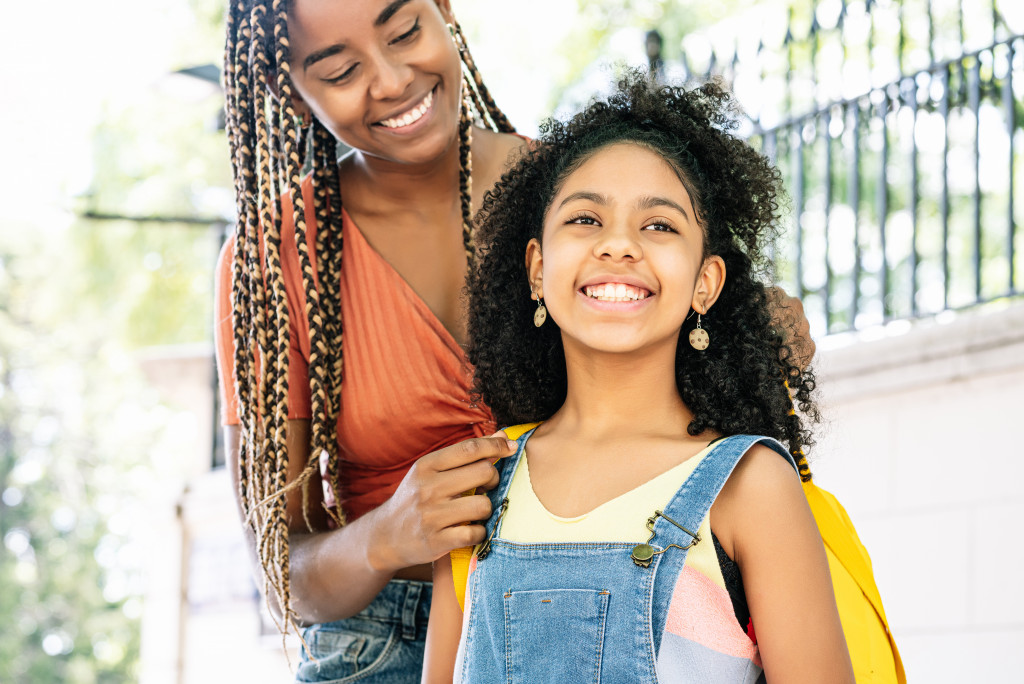 A daughter going to school with her mother