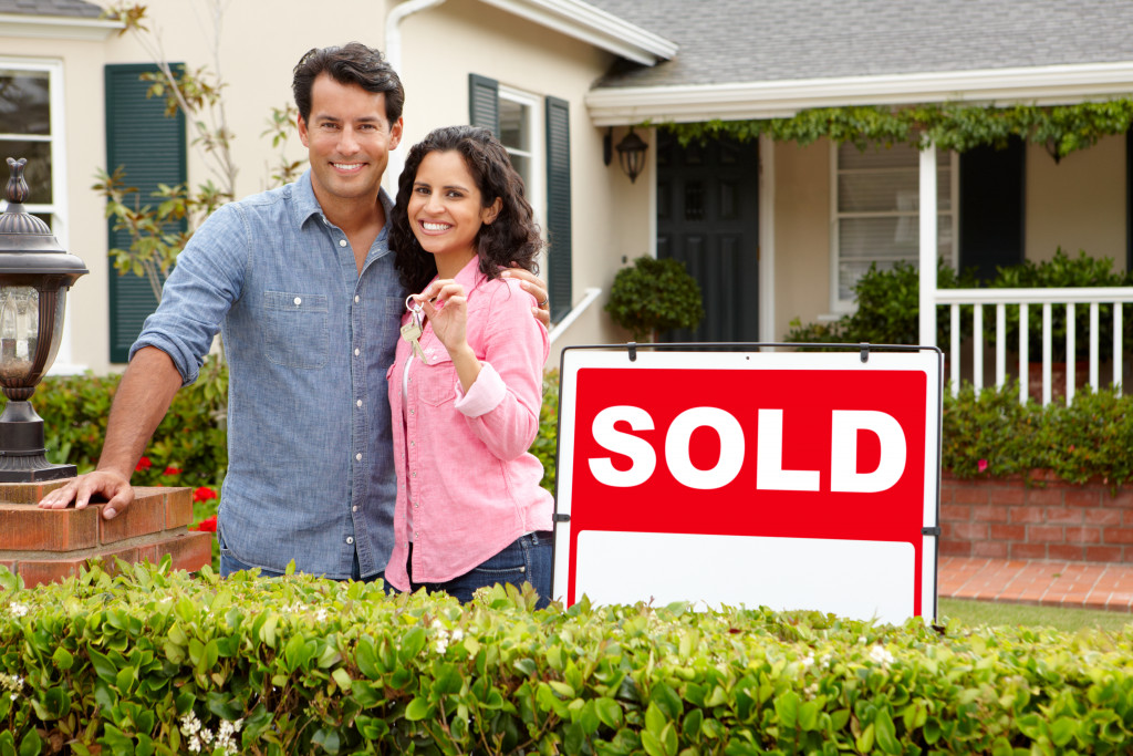 A couple outside a sold house