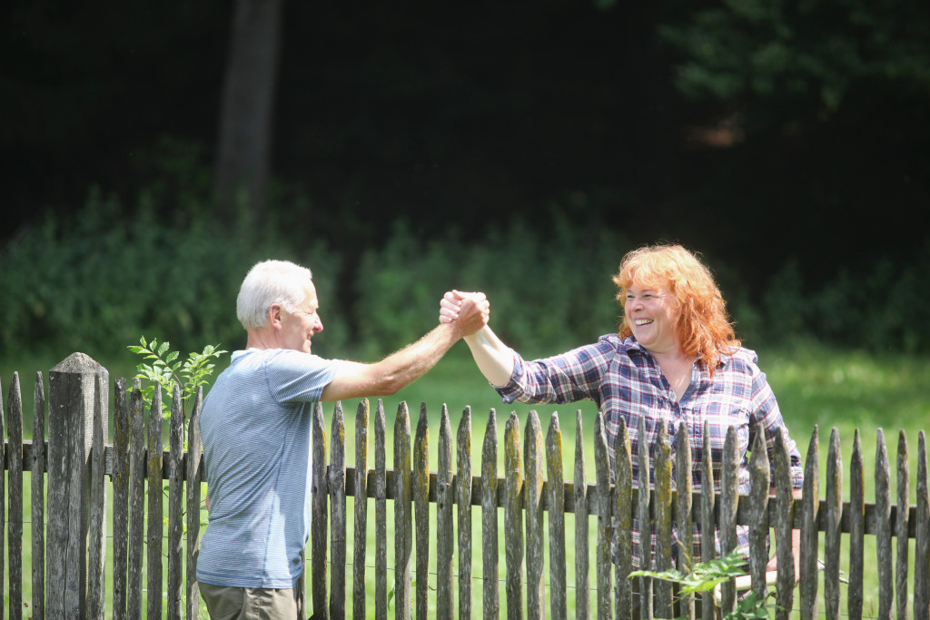 two neighbors outdoor greeting each other