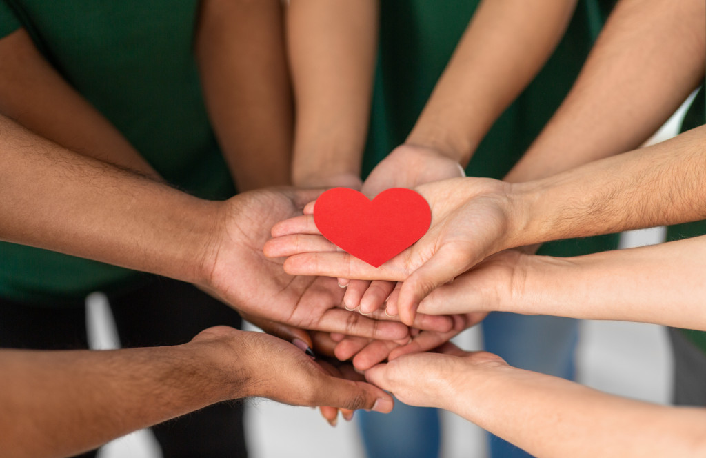 nonprofits members holding one paper heart